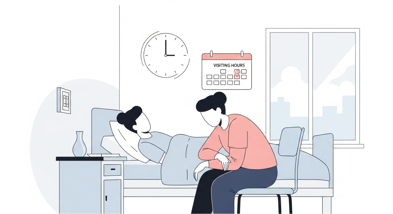 Seorang ahli keluarga sedang duduk di sisi katil dan memegang tangan pesakit di dalam wad