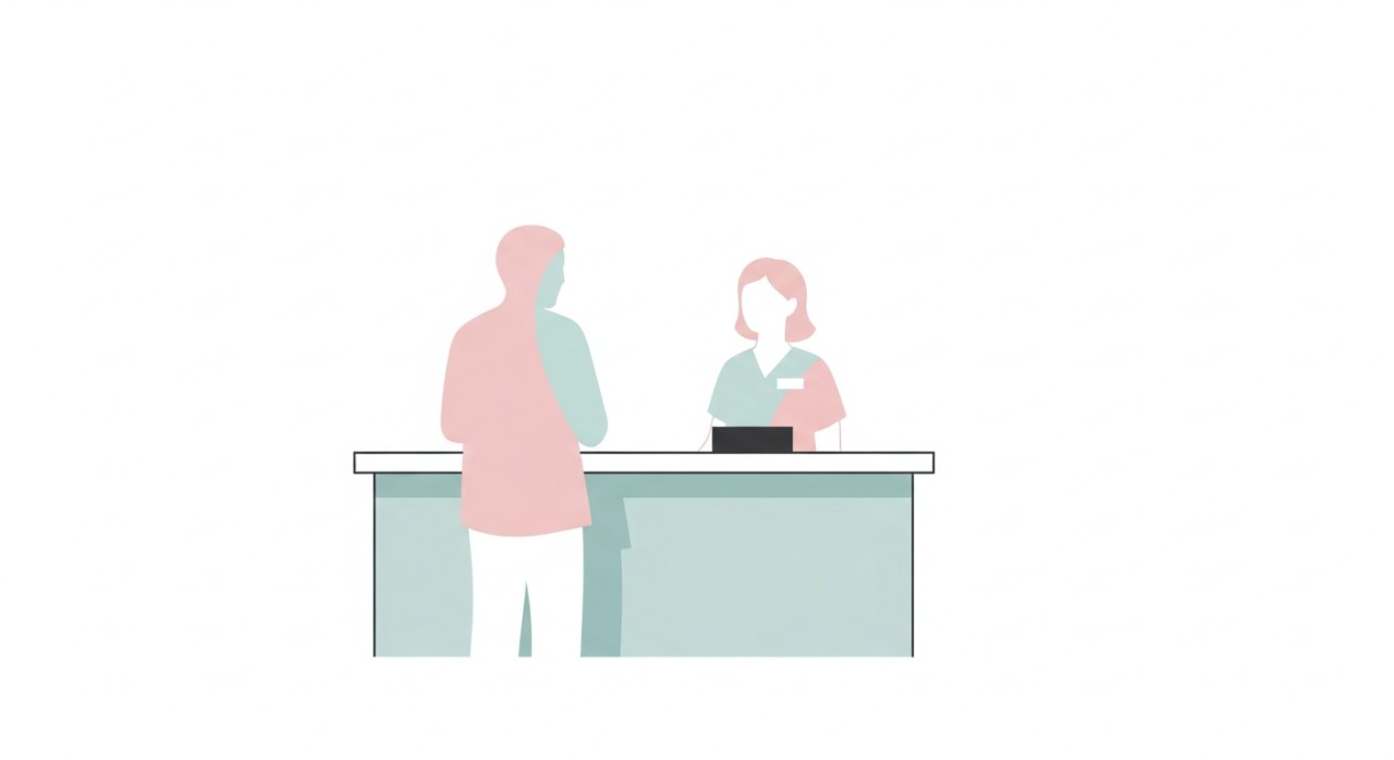 Seorang pesakit sedang berinteraksi dengan petugas di kaunter pendaftaran hospital.